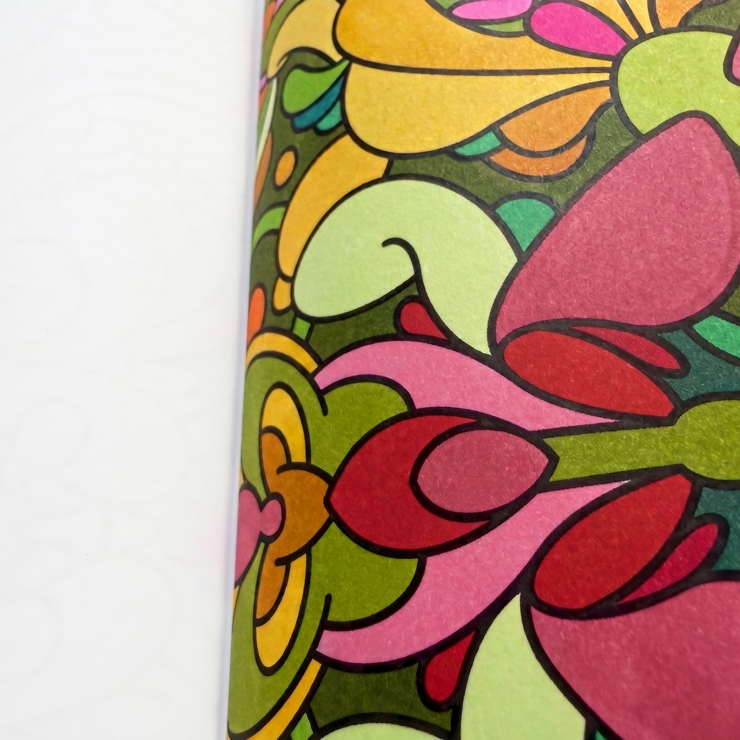 Macro close-up of smooth, vibrant marker blending on a dense floral page inside the BOTANICA coloring book.